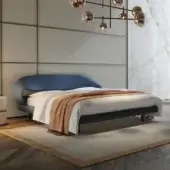 Elegant Reflex Nuvola bed presents an organic silhouette with curved headboard and sides upholstered in stylish blue textile with matte finish