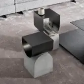Distinguished Bonaldo Vague coffee table with sculptural form in black matte metal and light-toned concrete-look base crafted in Italy