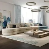 Sophisticated Reflex Adone sectional with rounded shapes upholstered in beige textile and goose feather cushions