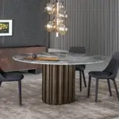 Architectural Bonaldo Dorian table with round marble top displaying gray and white veining and sculpted bronze-toned base