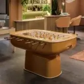 Refined Vismara Oskar foosball table with glossy muted yellow-orange lacquered structure and precision turned aluminum players with tempered glass field
