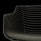 Flowfilo chair back, matte bronze metal, parallel curved rods forming a wave-like minimalist geometric pattern against black backdrop.