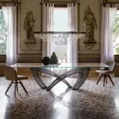 Distinguished Cattelan Italia Hystrix table with a clear glass top and interwoven dark metal base presenting a sculptured design