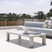 Distinguished Varaschin Customade coffee table with a smooth matte off-white synthetic material and cylindrical legs