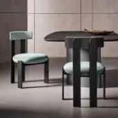 Sophisticated Bonaldo Pi chair with light blue-green fabric and dark matte wood evoking geometric form