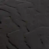 Black glass texture with rippled surface and reflective finish, displaying irregular dark lines and a fluid, dynamic pattern under diffused lighting.