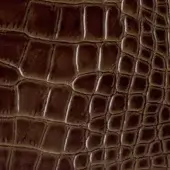 Brown crocodile leather texture with raised, rounded scales in a grid pattern and matte finish.