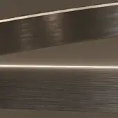 Layered wall panels in satin iron grey with stepped configuration, featuring horizontal illumination and brushed linear texture.