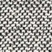 Off-white and black textile sample displaying a repeating, high-contrast geometric pattern resembling a houndstooth with a dense, nubby weave.