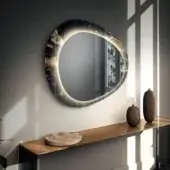 Exceptional Lago Era mirror with organic oval silhouette crafted in XGlass and simulated stone with integrated LED lighting