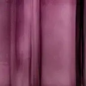 Ametista tau sheer fabric drapes with soft vertical folds, displaying a muted dusty purple and subtle translucence with a dark stripe edge.