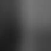 Gray gradient background, blurred transition from dark to light gray, monochromatic composition with diffused lighting and indistinct visual structure.