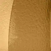 Textured wall with curved architectural division, featuring amber and yellow-ochre tones, rough stucco finish, and granular surface detail.
