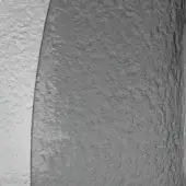 Mottled gray wall texture with white curved edge, granular surface, and irregular bumps; diffused lighting highlights architectural detail.