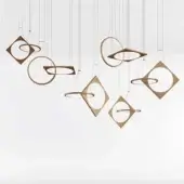 Copper drop suspension lamps with square metal frames and intersecting circular rings are arranged asymmetrically against a white background.