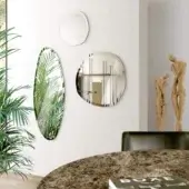 Exceptional Pacini & Cappellini Stone mirror with irregular shape and smooth finish crafted in a light-toned frame