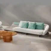 Distinguished Reflex Segno sofa with speckled light gray textile upholstery and turquoise cushions against a slatted light gray solid surface frame