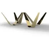 Sculptural pedestal, polished gold-toned metal, featuring undulating angular forms and a repeating wave-like silhouette against a white backdrop.