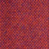 Textile sample, orange and indigo, dense woven texture with speckled granular pattern and visible fibers, studio lighting.