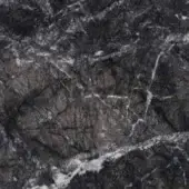 Grigio carnico marble texture features dark gray and white veins, layered fracturing, and a matte, rugged surface with horizontal fissures.