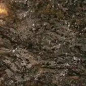 Dark brown mottled texture with beige and cream tones, featuring irregular metallic inclusions and a dense, granular interwoven structure.
