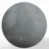 Circular steel disc with mottled gray texture against white background, exhibiting tonal gradient and granular surface detail.