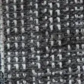 Woven fabric texture, dark gray and off-white, displays a dense grid pattern with vertical lines and a raw, unfinished edge.