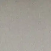 Gray granular texture with mottled tone, displaying a uniform matte finish and subtle irregularities across the surface, illuminated by diffuse light.