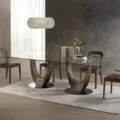 Distinguished Pacini & Cappellini Axis table with a tempered glass top and sculptural medium-toned brown wood base supported by chromed metal plates