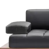 Black leather modular sofa section with quilted detailing, square cushion, and dark wood base, studio shot, geometric design.