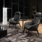 Distinguished Wayne Enterprises WE-130 lounge chair with dark leather upholstery and medium-toned wooden legs crafted in Italy