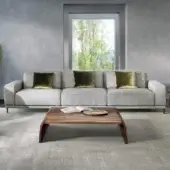 Distinguished Pacini & Cappellini Costanza sofa with light textured fabric upholstery and olive green velvet cushions built on dark wood feet