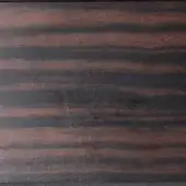 Ebony wood panel with horizontal linear grain, matte finish, and tonal variations from dark to reddish-brown, showing subtle surface wear.