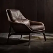 Distinctive Wayne Enterprises WE-053 lounge chair upholstered in rich brown leather with a dark-toned wood frame and curved angular forms