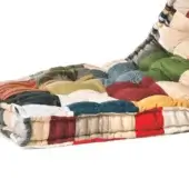Patchwork floor cushion, multi-colored fabric, modular design with camouflage, stripes, red, blue, and green squares, neatly stitched.