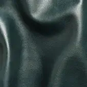 Dark teal leather sheet with granular texture, folded in undulating shapes, glossy finish, studio gray background.