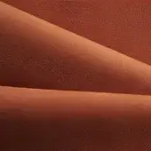 Folded nk rust textile with a pebbled texture, displaying three overlapping layers and subtle tonal variations under diffused lighting.
