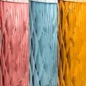 Glass vases, textured surface, red, blue, and mustard colors, cylindrical shape, intersecting lines, handcrafted appearance, neutral background.