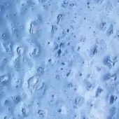Blue Dali collection texture with translucent droplet formations, glossy finish, granular surface, and distorted pale blue reflections.