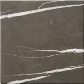 Dark grey marble tile sample with diagonal white veining, mottled texture, and matte finish, displaying natural stone variations.