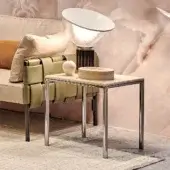 Refined Turri Ratio side table with a glossy metal frame and light beige marble-like surface exhibiting subtle veining