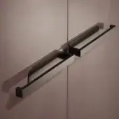 Bellavista handles in brushed stainless steel, rectangular form with central connecting bar, mounted on light brown flush doors.