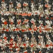 Dark gray woven fabric with muted orange, cream, and pale green floral motifs; visible texture and a complex, layered pattern.