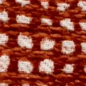 Woven fabric texture with repeating white floral motifs on reddish-brown, featuring a dense looped, nubby surface and abstracted swan shapes.