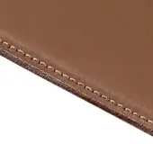 Brown leather hide close-up displaying detailed edge stitching, smooth surface, and contrasting fibrous underside texture against a white backdrop.
