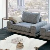 Superior Turri Blues lounge chair with textured medium gray textile upholstery and Canaletto walnut with bronze metal details