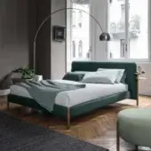 Stylish Bolzan Letti Flag bed with green textile upholstery, light-brown wood legs and integrated golden-brass side tables