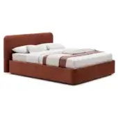 King bed with rust-orange upholstery, rectangular headboard, white linen bedding, and platform base in a bright studio setting.