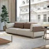 Distinguished Turri Drum sofa with light beige textile upholstery and rich brown leather cushions, built with a walnut wood frame and bronze details