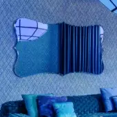 Superior Turri Azul mirror with organic silhouette and beveled blue reflective glass crafted in fluted fabric-like elements with textured matte finish